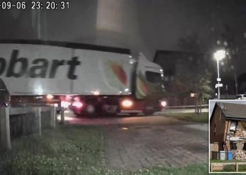 Truck rams house
