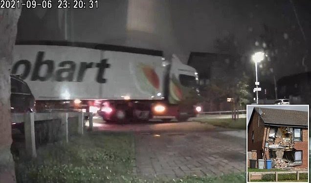 Truck rams house