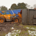 Toppled trailer dumps manure near busy roundabout